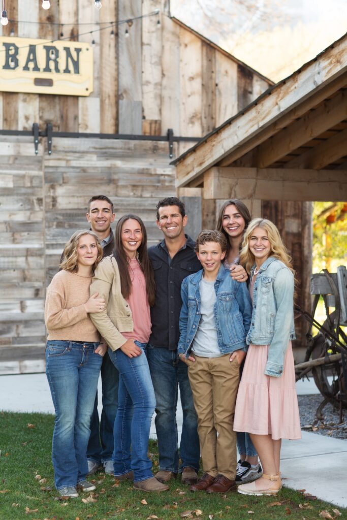 Family photo in front of barn at The Grand Ranch owners