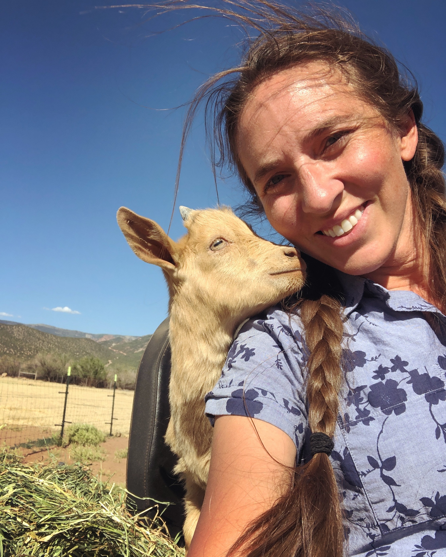 Girl with goat at The Grand Ranch petting zoo