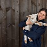 Hold a mini goat or lamb at The Grand Ranch Tour